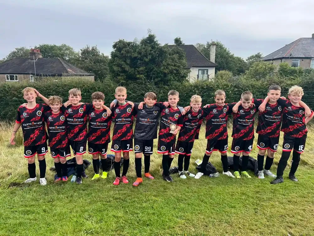 Squirrel Energy sponsored youth football team in black and red kits