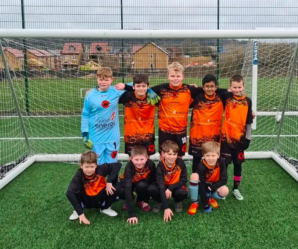 Squirrel Energy sponsored youth football team in orange and black kits